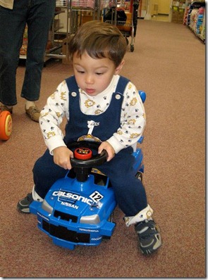 baby driving scooter car by egg on stilts via Flickr